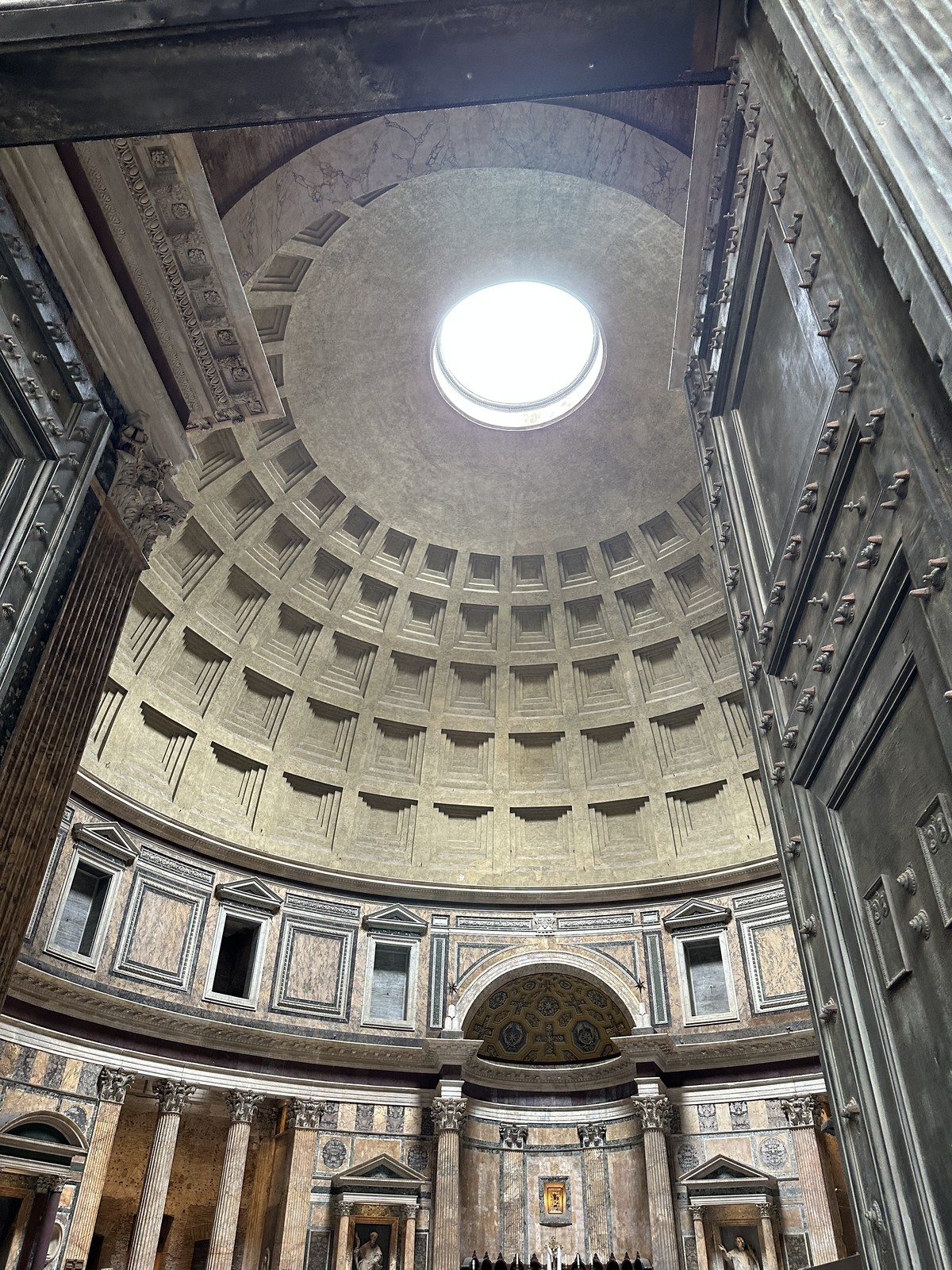 Interior of the Pantheon in Rome showing the domed ceiling with its central oculus letting in natural light