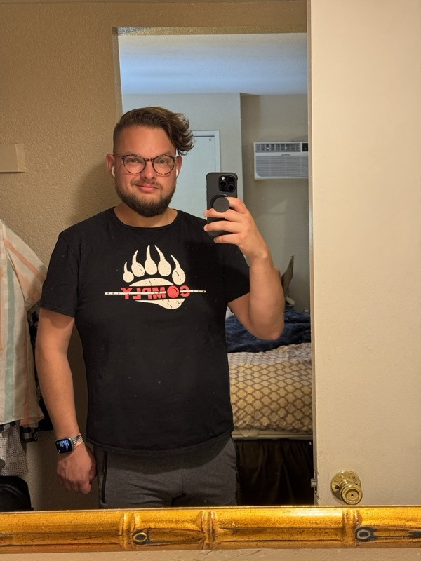 Mirror selfie in a bear paw t-shirt, getting ready to board the Sunset Limited in Palm Springs