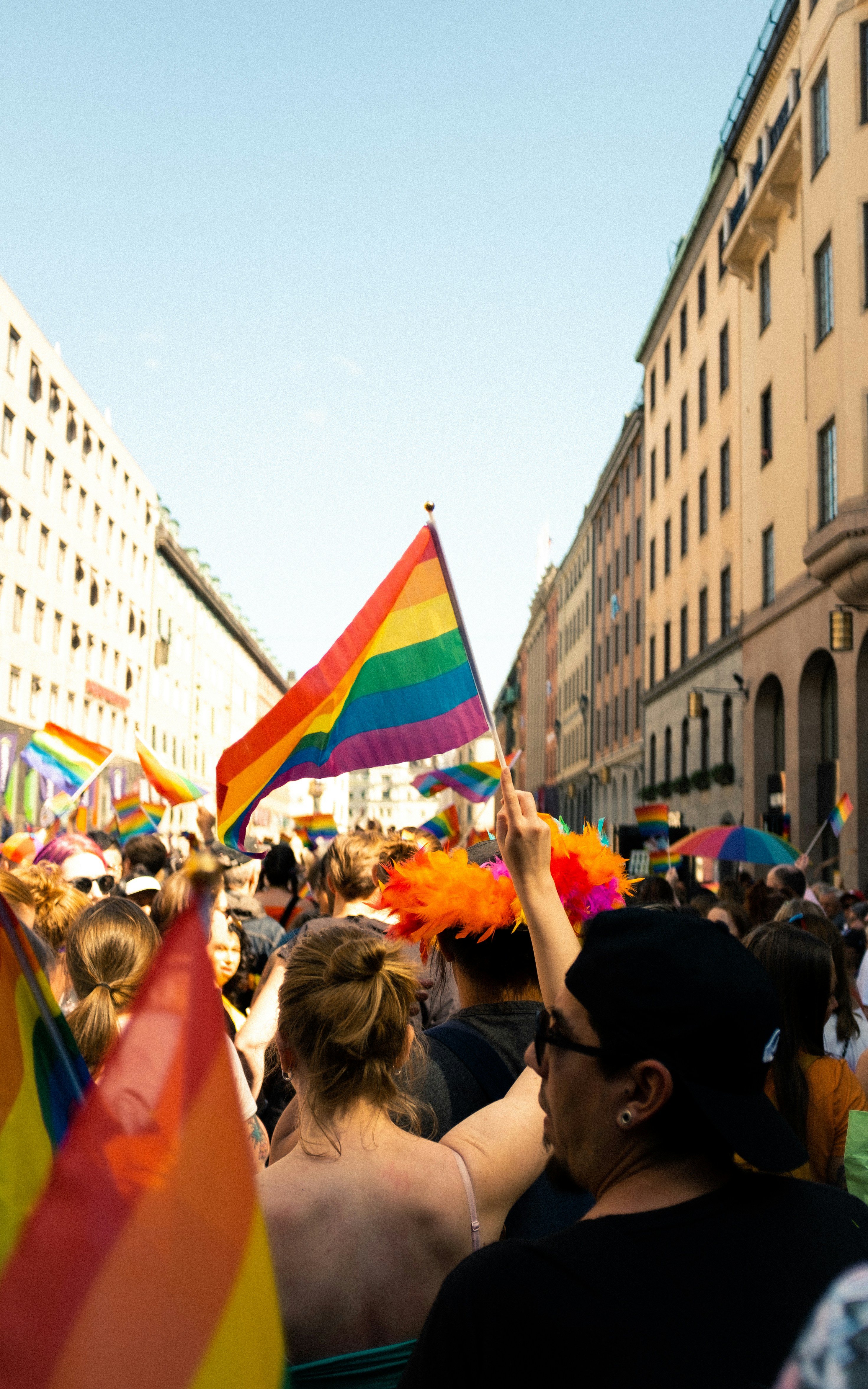 LGBTQ+ community members gathered together with pride flags