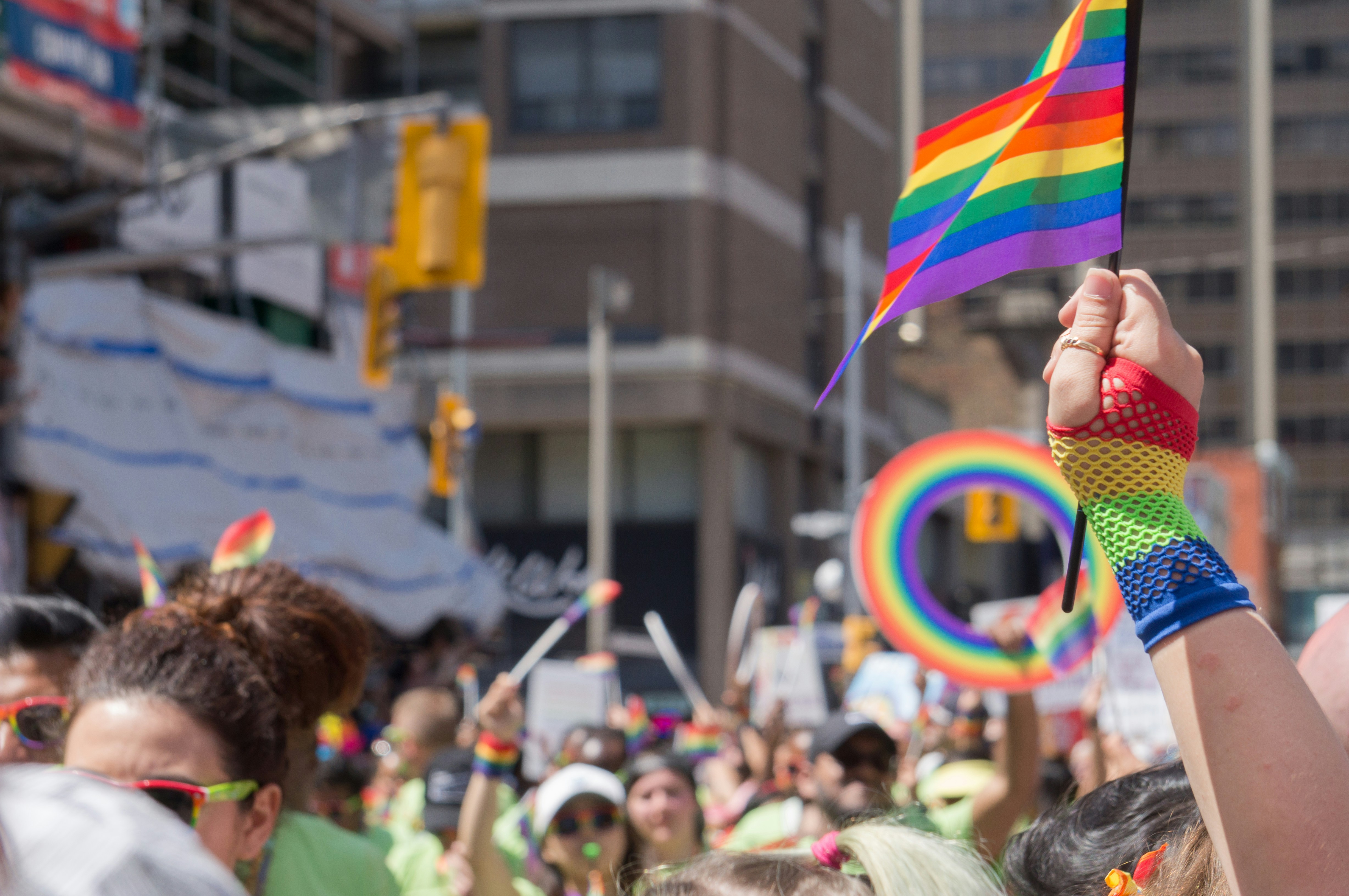 LGBTQ+ people waving pride flags in celebration